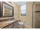Cozy bathroom featuring a shower, large mirror, granite countertop, and neutral colors at 820 Placid Lake Dr, Osprey, FL 34229