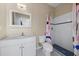 Bright bathroom featuring a white vanity, mirror, toilet, and shower with colorful curtain at 820 Placid Lake Dr, Osprey, FL 34229