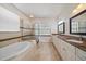 Luxurious bathroom with a soaking tub, walk-in shower, and double vanity with granite countertops at 820 Placid Lake Dr, Osprey, FL 34229