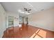 Bright bedroom featuring a ceiling fan, hardwood floors, and multiple entryways at 820 Placid Lake Dr, Osprey, FL 34229