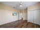 Bright bedroom with hardwood floors, a ceiling fan, mounted TV, and ample closet space at 820 Placid Lake Dr, Osprey, FL 34229