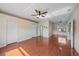 Large bedroom featuring a ceiling fan, hardwood floors, and multiple closets and doorways at 820 Placid Lake Dr, Osprey, FL 34229