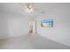 White bedroom with a ceiling fan, carpet floors, and a television on the wall at 820 Placid Lake Dr, Osprey, FL 34229