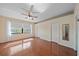 Spacious bedroom featuring a ceiling fan, hardwood floors, closets, and a water view at 820 Placid Lake Dr, Osprey, FL 34229