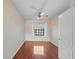 Small bedroom with hardwood floors, a ceiling fan, and a window with sheer curtains at 820 Placid Lake Dr, Osprey, FL 34229