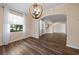 Open dining area features hardwood floors, modern light fixture, and an abundance of natural light at 820 Placid Lake Dr, Osprey, FL 34229