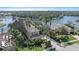 Beautiful waterfront home with lush tropical landscaping and paver driveway, providing exceptional curb appeal at 820 Placid Lake Dr, Osprey, FL 34229