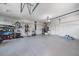 Spacious garage with epoxy flooring, storage racks, and room for multiple vehicles at 820 Placid Lake Dr, Osprey, FL 34229