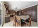 Kitchen boasts dark wood cabinets, granite counters, stainless steel appliances, and a cozy dining area at 820 Placid Lake Dr, Osprey, FL 34229