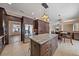 Open kitchen boasts dark wood cabinets, stainless steel appliances, and large granite island with seating at 820 Placid Lake Dr, Osprey, FL 34229
