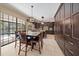 Bright kitchen with island seating, granite countertops, and stainless appliances overlooks a serene outdoor pool at 820 Placid Lake Dr, Osprey, FL 34229