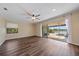 Spacious living room with wood floors, ceiling fan, and large sliding doors to the outdoor patio at 820 Placid Lake Dr, Osprey, FL 34229