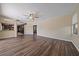 Open-concept living room with wood floors, ceiling fan, and view into kitchen and dining areas at 820 Placid Lake Dr, Osprey, FL 34229