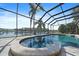 Beautiful screened-in pool and spa with views of the lake at 820 Placid Lake Dr, Osprey, FL 34229