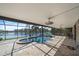 Screened pool and spa overlook the lake and lush landscaping at 820 Placid Lake Dr, Osprey, FL 34229