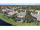 Aerial view of a home with screened in pool overlooking the water, offering privacy and relaxation at 820 Placid Lake Dr, Osprey, FL 34229