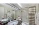 Bright bathroom with granite counter, large mirror and shower/tub combination at 820 Whitfield Ave, Sarasota, FL 34243