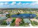 A stunning aerial view of a home with a red-tiled roof in a community surrounded by several ponds at 9039 Willowbrook Cir, Bradenton, FL 34212