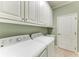 Well-equipped laundry room includes a washer, dryer, sink and plenty of storage space at 9039 Willowbrook Cir, Bradenton, FL 34212