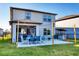 A view of the rear of the home, with covered patio and outdoor kitchen and backyard playground at 9091 Royal River Cir, Parrish, FL 34219