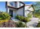 Inviting entrance with dark door and lush landscaping at 9091 Royal River Cir, Parrish, FL 34219