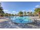 Community pool with palm trees and clear blue water on a sunny day at 9091 Royal River Cir, Parrish, FL 34219