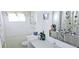 Bright bathroom features a vanity, medicine cabinet, toilet, and shower with butterfly curtain at 10315 Cortez W Rd # 28-1, Bradenton, FL 34210