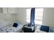 Cozy bedroom featuring twin beds, a nightstand, blue accents, and a bright window at 10315 Cortez W Rd # 28-1, Bradenton, FL 34210