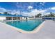Sparkling community pool with ample lounge seating and sunbathing area at 10315 Cortez W Rd # 28-1, Bradenton, FL 34210
