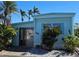 Charming single-story home featuring blue siding, well-maintained landscaping, and a welcoming front entrance at 10315 Cortez W Rd # 28-1, Bradenton, FL 34210