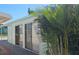 Exterior view of the home with palm trees, a sidewalk, and plenty of natural light at 10315 Cortez W Rd # 28-1, Bradenton, FL 34210