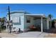Exterior view of the home with a carport, kayak, and neatly landscaped surroundings at 10315 Cortez W Rd # 28-1, Bradenton, FL 34210