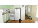 Efficient kitchen with light green cabinetry, white appliances, double sink and great natural light at 10315 Cortez W Rd # 28-1, Bradenton, FL 34210