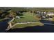 Picturesque aerial shot of a golf course and country club surrounded by water and trees at 10406 Eastwood Dr, Bradenton, FL 34211
