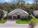 Aerial view of a house with a well-maintained lawn, a brick driveway, and an attached two-car garage at 10406 Eastwood Dr, Bradenton, FL 34211