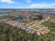An aerial view showcases a community of single-Gathering homes, many with pools, surrounded by lush landscaping at 10406 Eastwood Dr, Bradenton, FL 34211