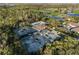 Stunning aerial shot showcasing tennis courts, a pool, and lush green surroundings, creating a serene and active lifestyle at 10406 Eastwood Dr, Bradenton, FL 34211
