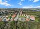 Aerial view of a beautiful home in a lush community with manicured lawns and mature trees under a blue sky at 10406 Eastwood Dr, Bradenton, FL 34211