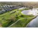 Scenic aerial view of the golf course homes and lake, with a lush green landscape and beautiful water features at 10406 Eastwood Dr, Bradenton, FL 34211