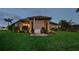 A backyard at dusk with a generator and an outdoor grill at 10406 Eastwood Dr, Bradenton, FL 34211