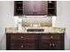 Elegant bar area with wine storage and granite countertop at 10406 Eastwood Dr, Bradenton, FL 34211