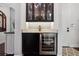 Stylish bar area with wine fridge, attractive cabinetry and granite countertop at 10406 Eastwood Dr, Bradenton, FL 34211