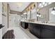 Luxurious bathroom with dual vanities, marble shower, and elegant chandelier lighting at 10406 Eastwood Dr, Bradenton, FL 34211
