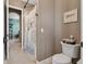 Bathroom with a toilet, shower with curtain, tile flooring, and neutral colored walls and doorway at 10406 Eastwood Dr, Bradenton, FL 34211