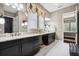 Elegant bathroom with dual sinks, granite countertops, decorative mirrors and crystal chandelier at 10406 Eastwood Dr, Bradenton, FL 34211