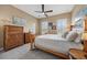Bedroom featuring a wooden bed frame, two wooden dressers, neutral carpet, and plantation shutters at 10406 Eastwood Dr, Bradenton, FL 34211