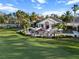 The outdoor patio dining area is surrounded by lush tropical landscape and overlooks the golf course at 10406 Eastwood Dr, Bradenton, FL 34211
