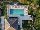 An overhead view of the community pool showcases lounge chairs, umbrellas, and lush landscaping at 10406 Eastwood Dr, Bradenton, FL 34211