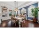 Elegant dining room with a stylish light fixture, wainscoting, and hardwood flooring at 10406 Eastwood Dr, Bradenton, FL 34211
