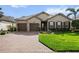 Charming single-story home featuring a brick driveway, manicured lawn, and a neutral color palette at 10406 Eastwood Dr, Bradenton, FL 34211